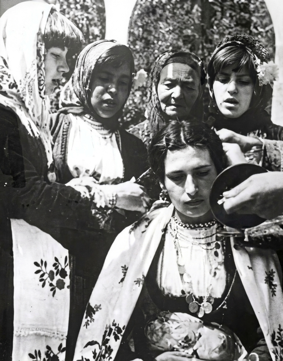 Black-and-white archival photograph of women and girls gathered around a Macedonian rain-making ritual