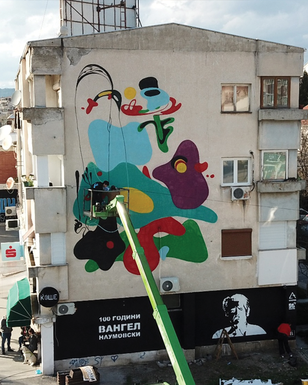 A large mural honoring Vangel Naumovski on a building in Ohrid
