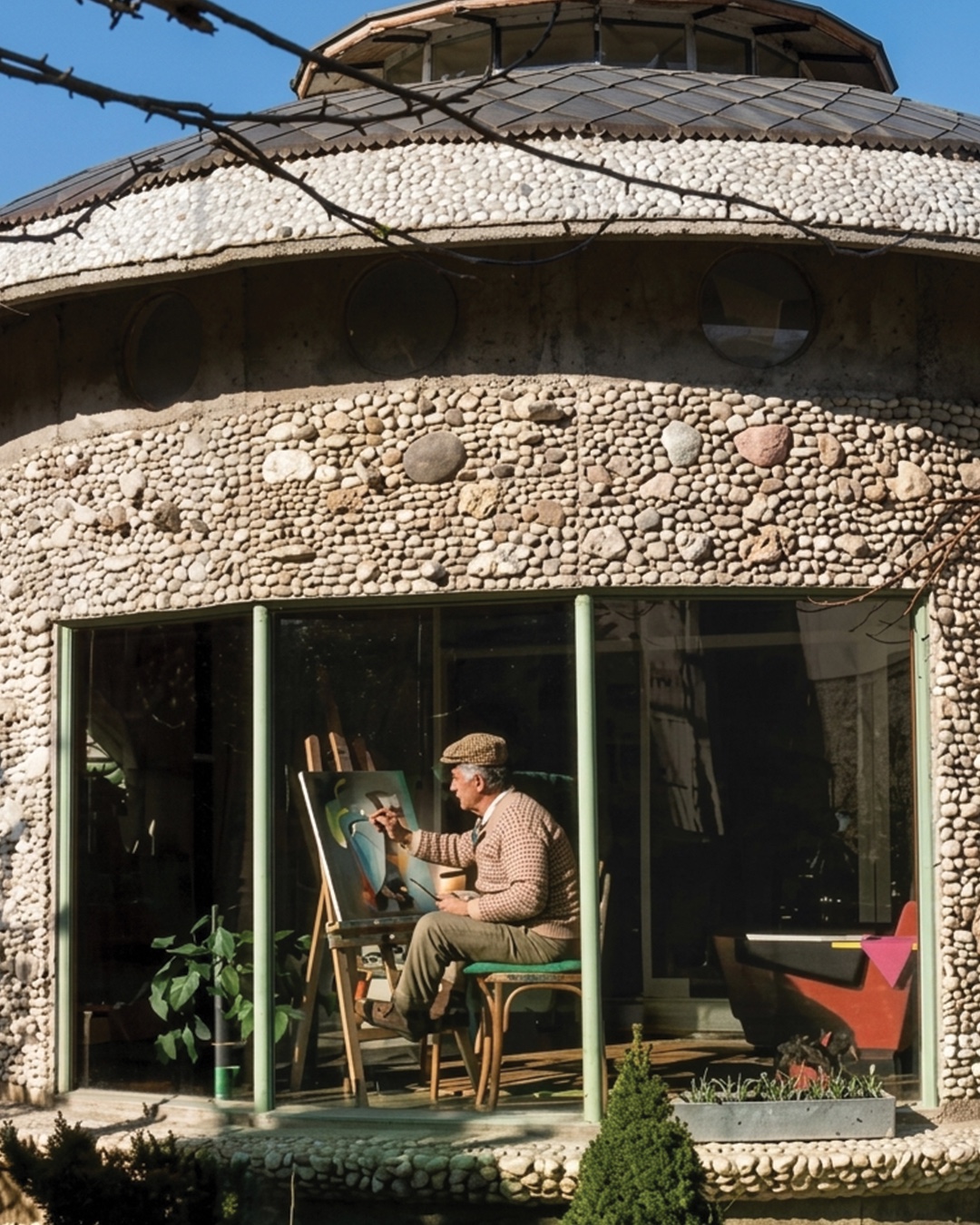 Vangel Naumovski painting inside his organically designed Ohrid studio